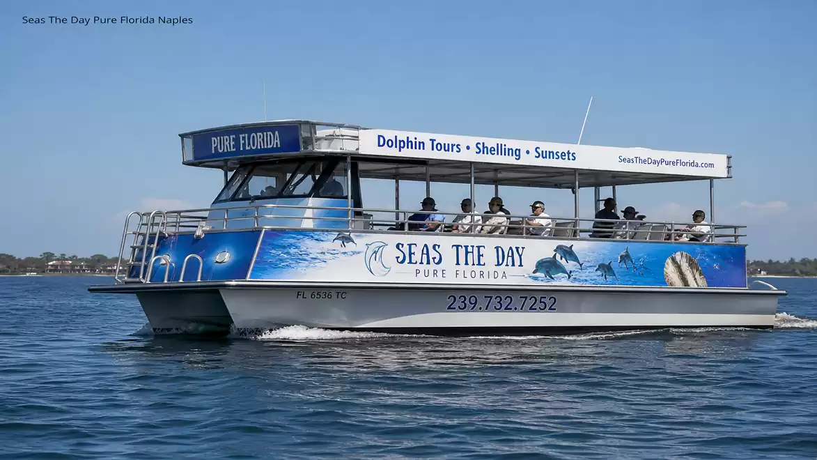 A tourist boat on the water with the text 'Seas The Day Pure Florida', offering dolphin tours, shelling, and sunsets.
