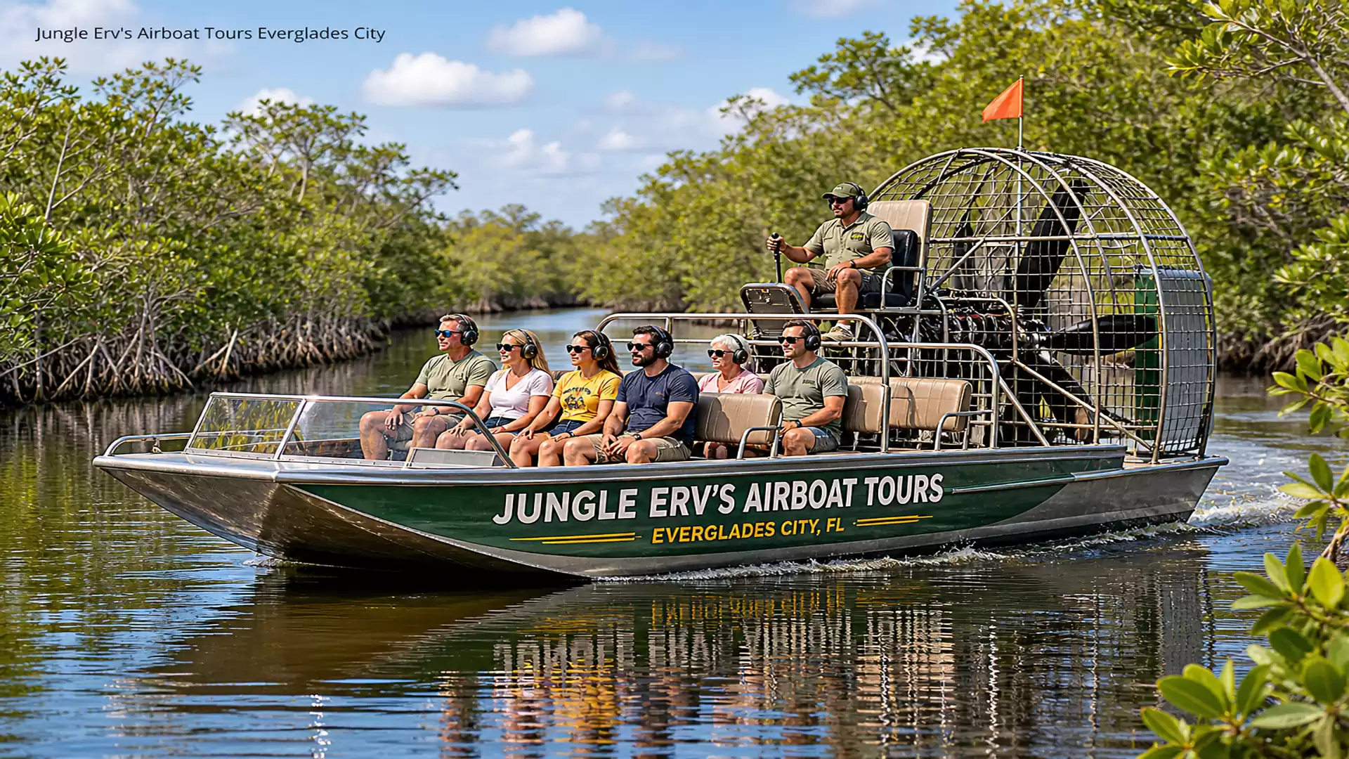 A group of people enjoying an airboat tour through the expansive, greenery-lined waters of the Everglades on a sunny day.
