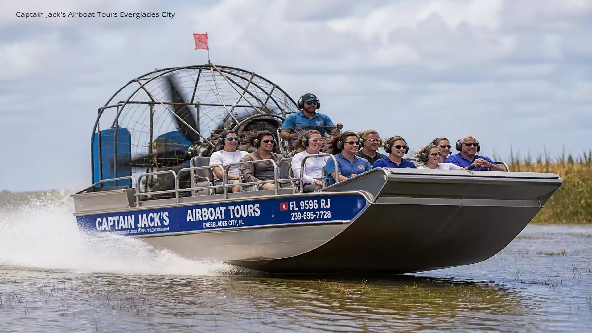 A group of people enjoys an airboat tour through the Everglades with Captain Jack's Airboat Tours on a sunny day.