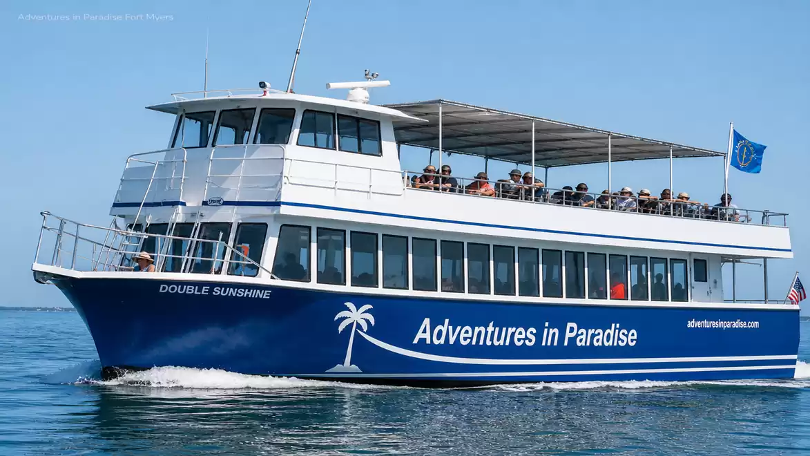 Image of a tourist boat named 'Double Sunshine' cruising on the sea on a sunny day. The side reads 'Adventures in Paradise'.