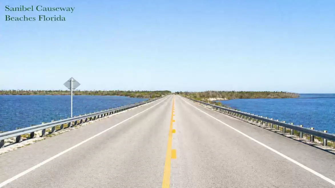 Sanibel Causeway in Florida, a paved road stretching over the sea with a blue sky in the background.