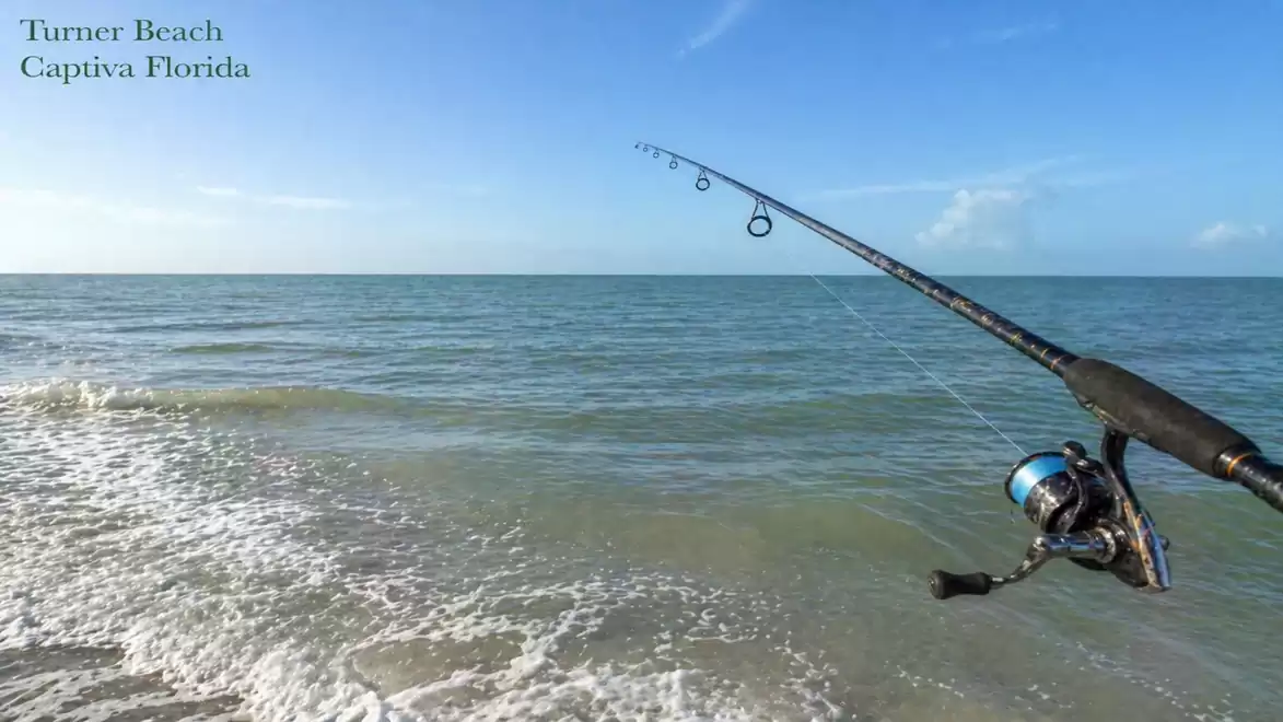 Fishing rod at Turner Beach, Captiva Florida with blue sky and calm sea.