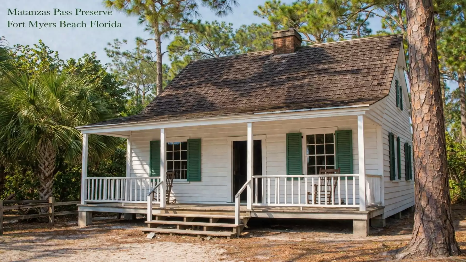 Historical wooden house in Matanzas Pass Preserve, Fort Myers Beach, surrounded by trees on a sunny day.