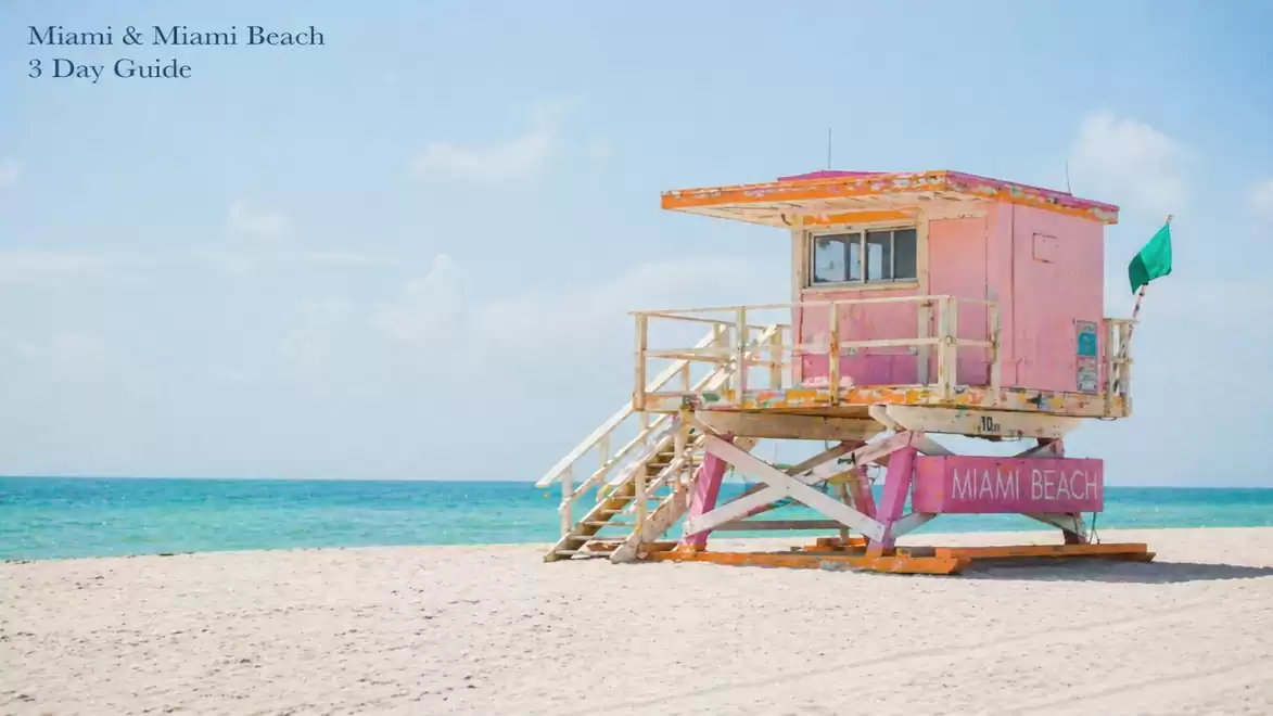 A pink lifeguard hut on Miami Beach with a clear blue sky in the background.