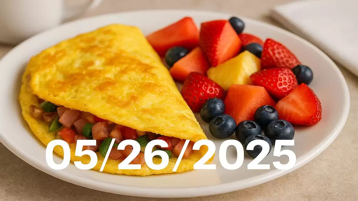 A plate with a filled omelette and fresh fruits like strawberries, blueberries, and pineapple. In the background, a white napkin and a cup. The date 05/26/2025 is overlaid.