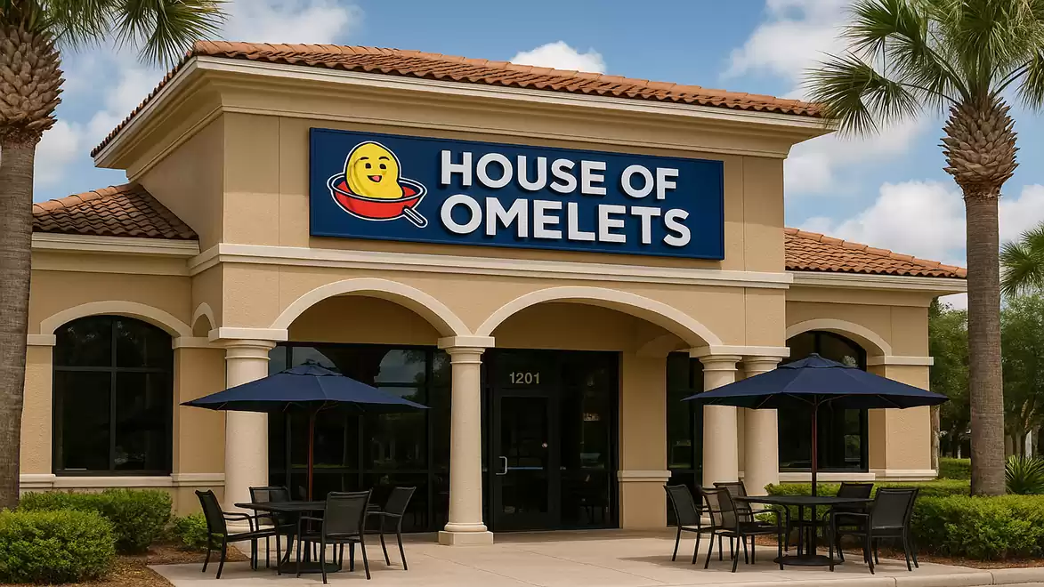 Exterior view of the House of Omelets restaurant with several tables under umbrellas on the patio.