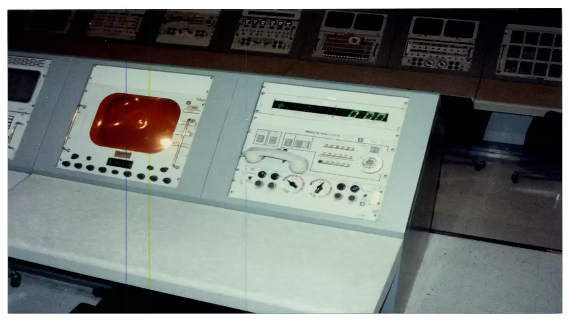 Historical control room console with screens and dials.