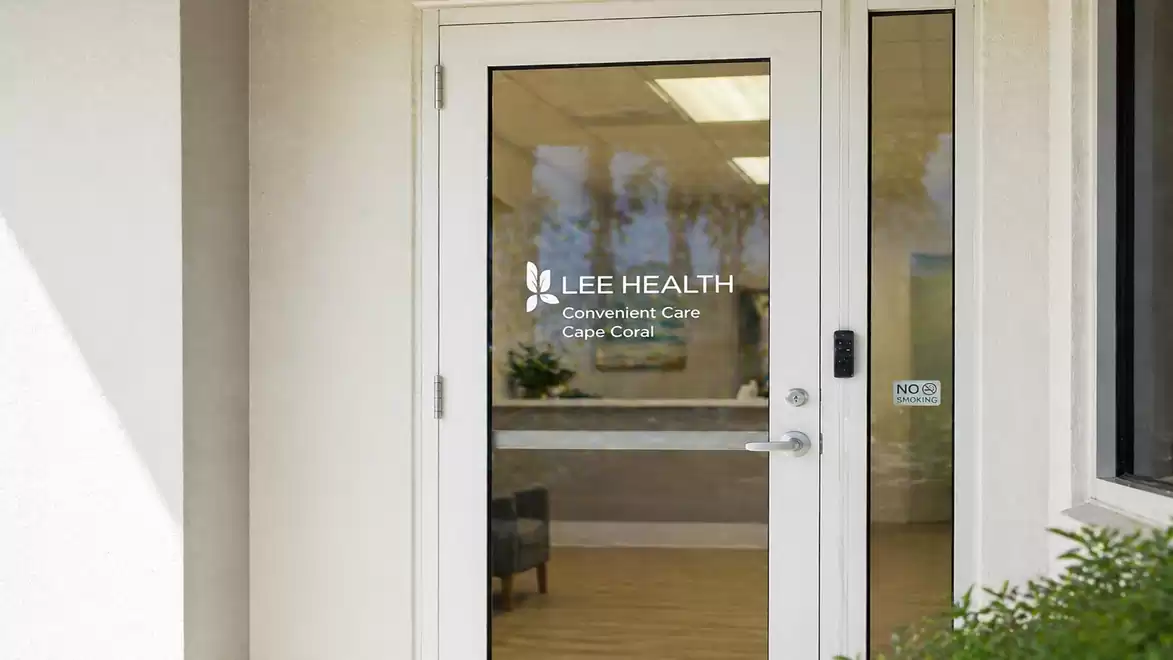 Entrance door to a health center with the logo 'Lee Health Convenient Care Cape Coral'.