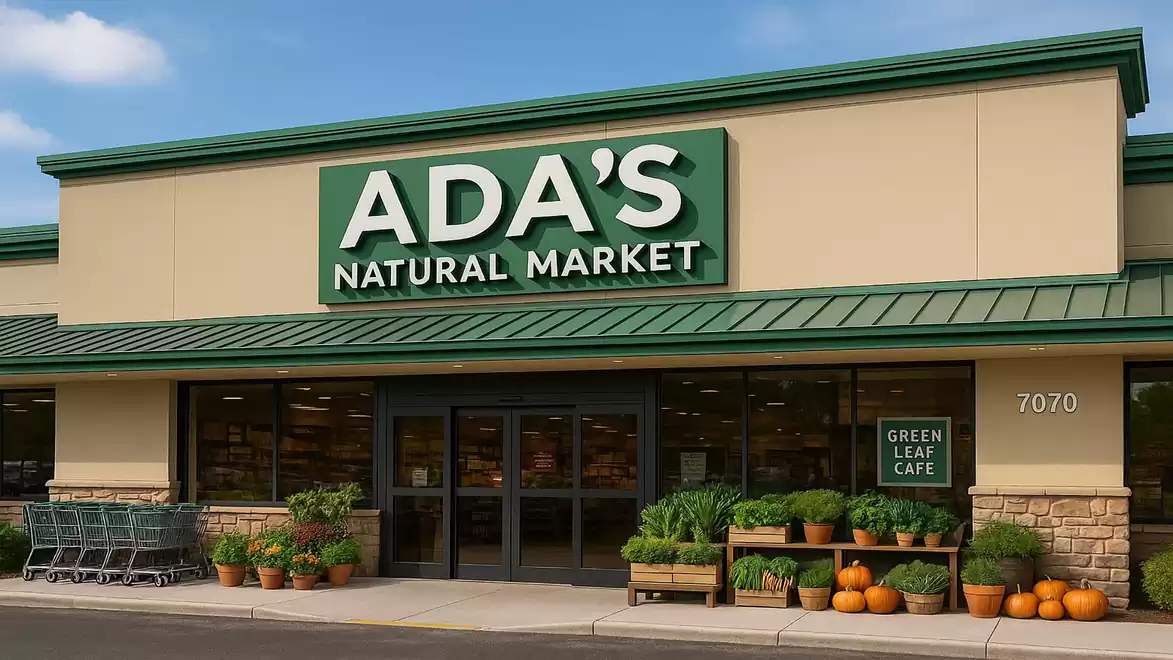 Entrance to Ada's Natural Market with shopping carts and pumpkins in front of the store.