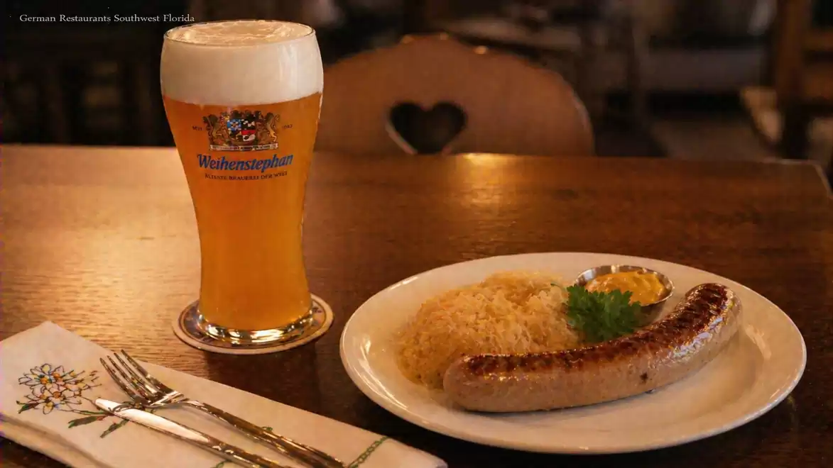 A mug of freshly poured beer and a plate with sausage and sauerkraut on a wooden table in a German restaurant.