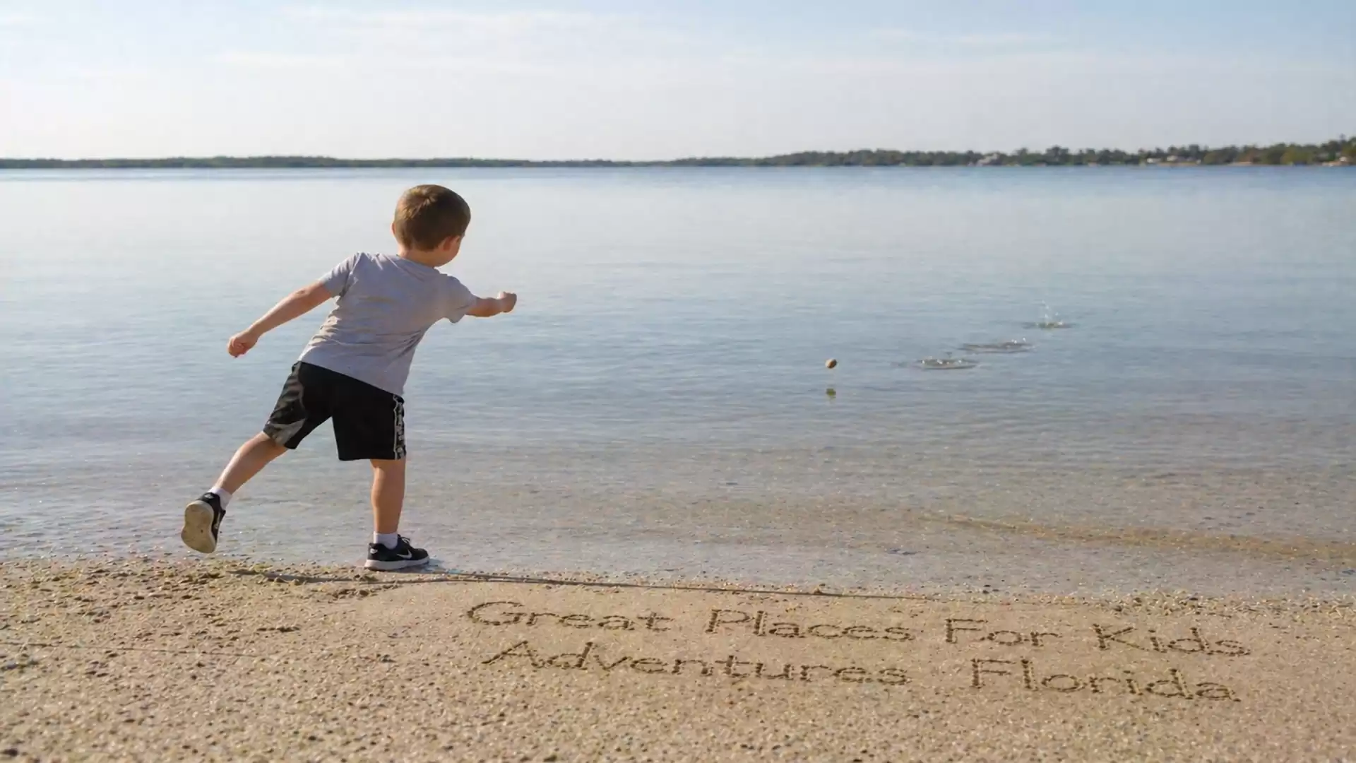 A boy skipping stones on the beach under sunny weather, with the text in the sand 'Great Places for Kids Adventures Florida'.