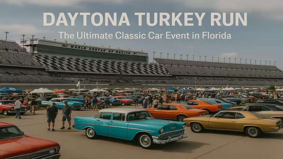Classic cars at the Daytona Turkey Run event in Florida in front of a race track.