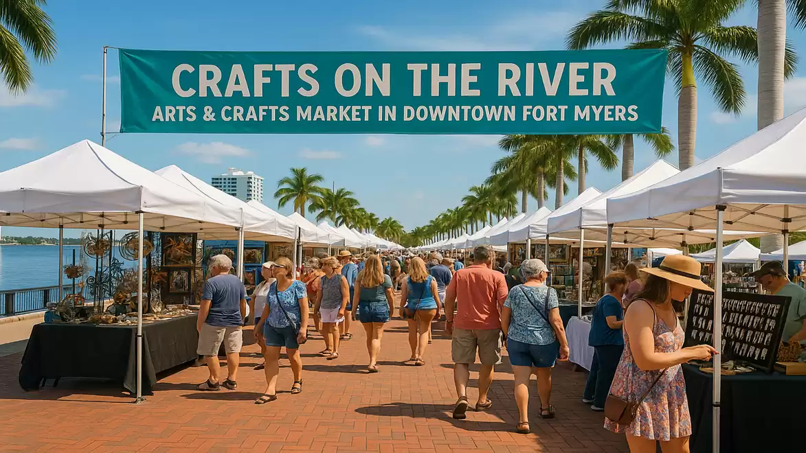 A craft market by the river in Fort Myers with people strolling between white tents, sunny weather, and palm trees in the background.