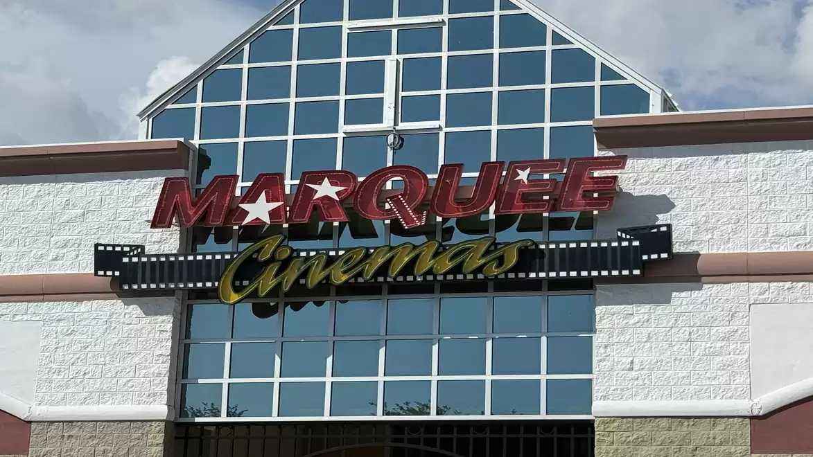 Entrance of Marquee Cinemas with large glass windows and the 'Marquee Cinemas' sign above.