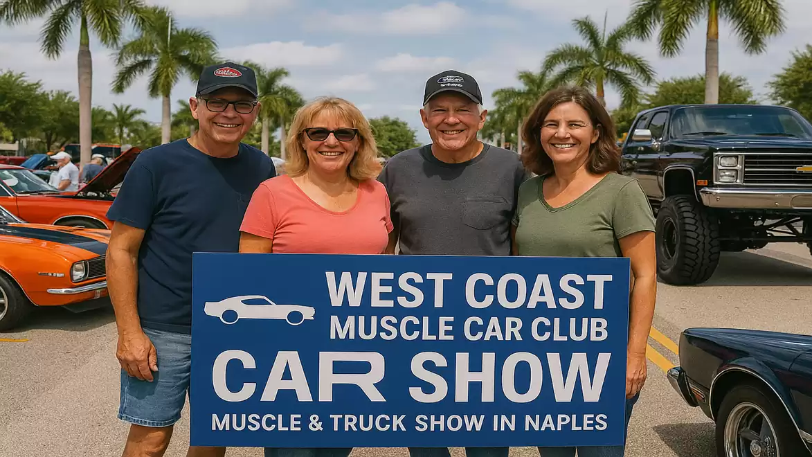 Four people stand in front of a West Coast Muscle Car Club sign with classic cars and palm trees in the background at a car show.