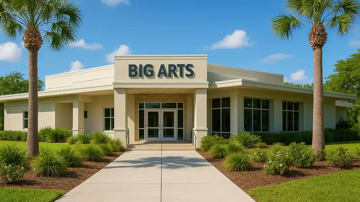 Modern art center with palm trees and a sleek facade on a sunny day.
