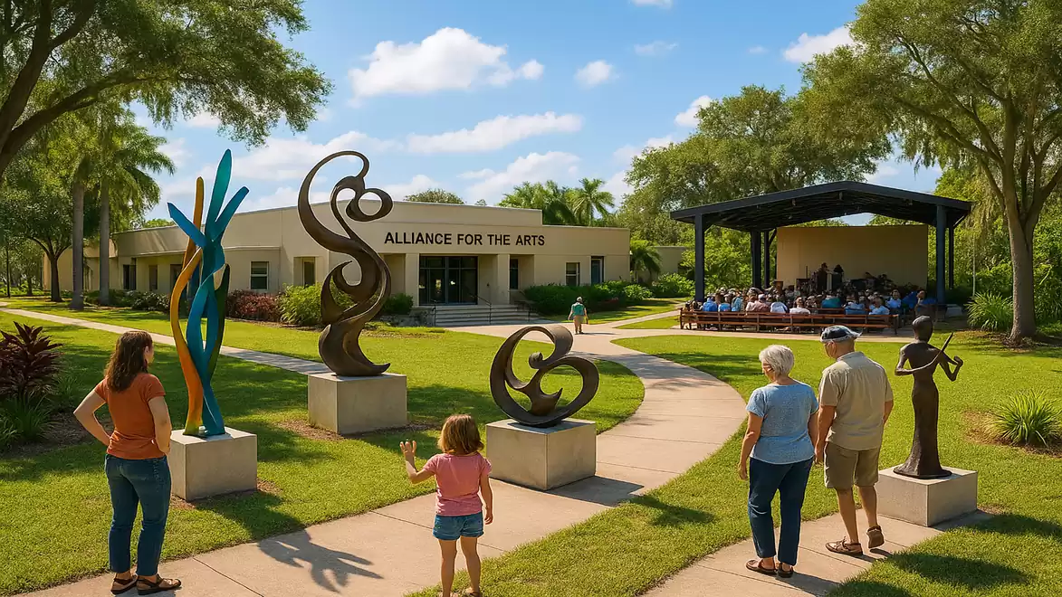 An art center with the sign 'Alliance for the Arts', surrounded by sculptures and visitors walking on a path. In the background, an event with spectators under a pavilion is visible.