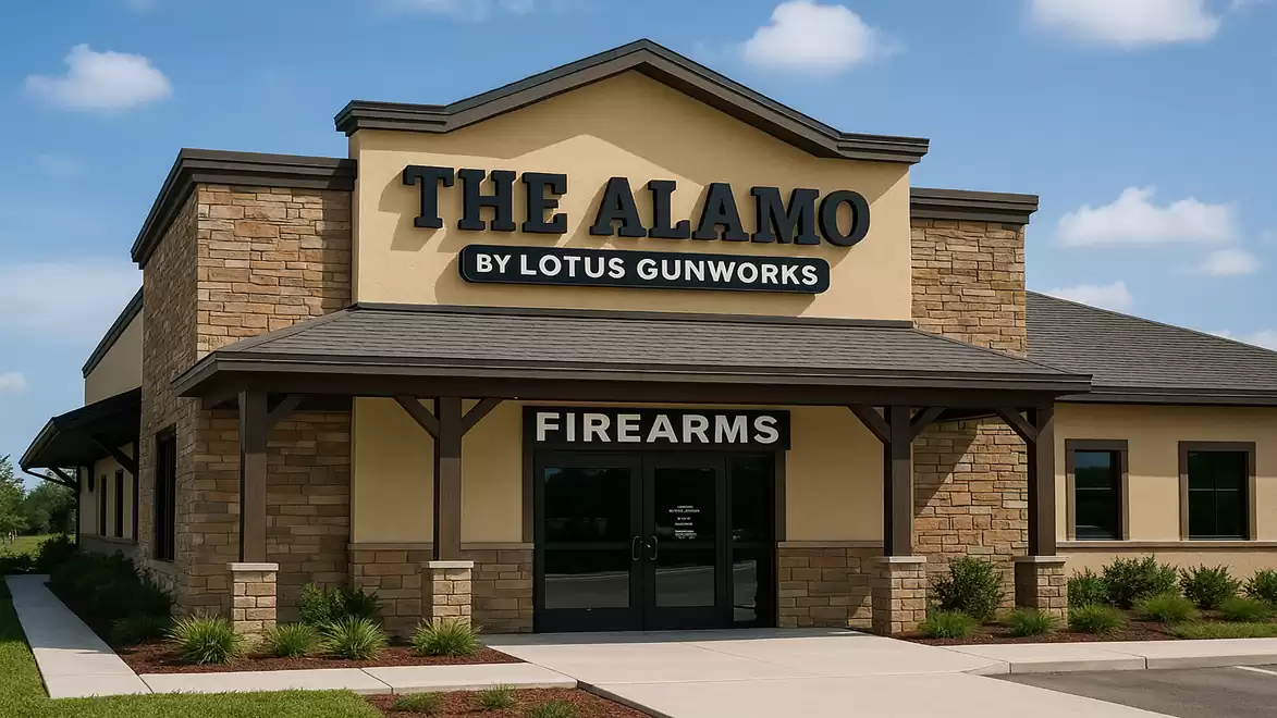 Exterior view of a building with the sign 'THE ALAMO BY LOTUS GUNWORKS', specializing in firearms.