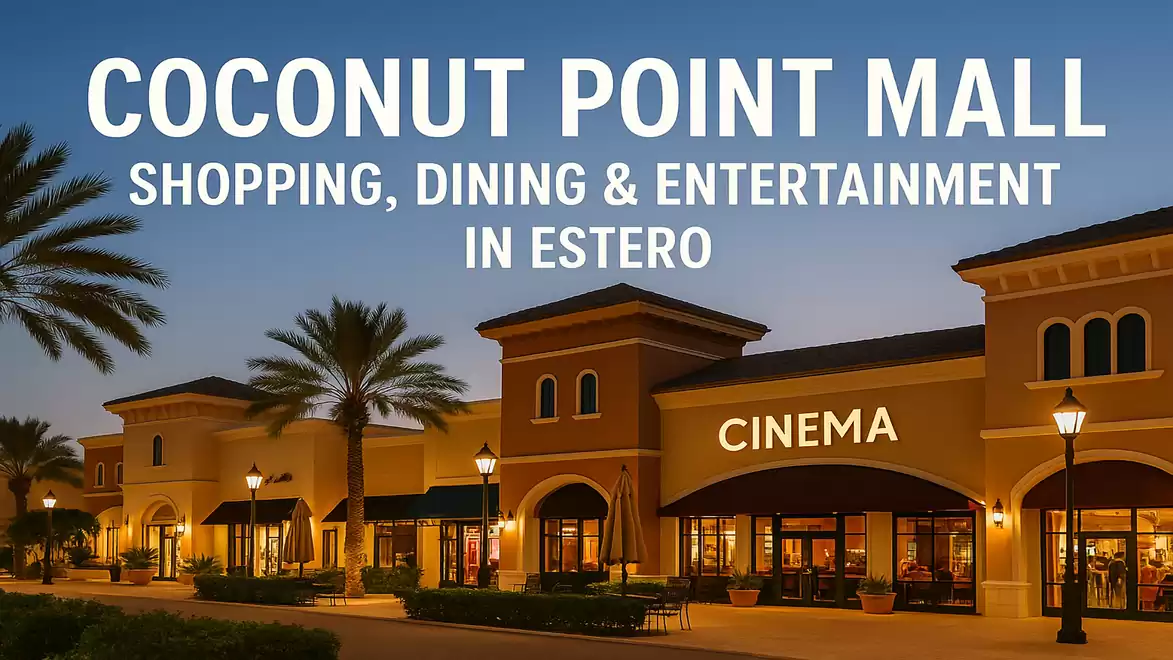 Evening view of Coconut Point Mall in Estero with illuminated buildings and palm trees, featuring cinema and shopping options.