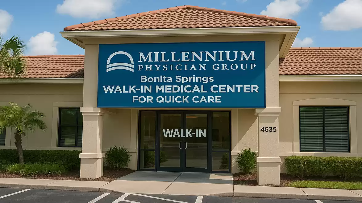 Entrance of a medical center with a large sign of Millennium Physician Group in Bonita Springs.