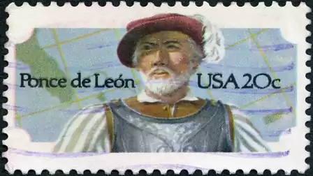 Stamp featuring a man in historical clothing and a hat. Beside him are the words 'Ponce de León' and 'USA 20c'. A map is in the background.