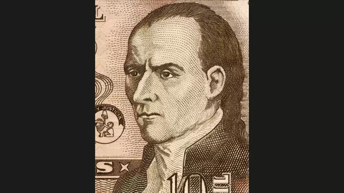 Close-up of a historical person on a banknote print, with a serious expression and gazing to the side.