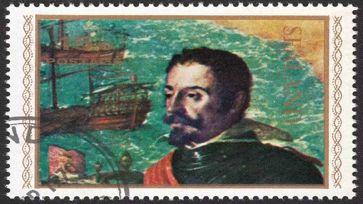 Postage stamp featuring a portrait of a man in historical clothing with a sailing ship in the background.