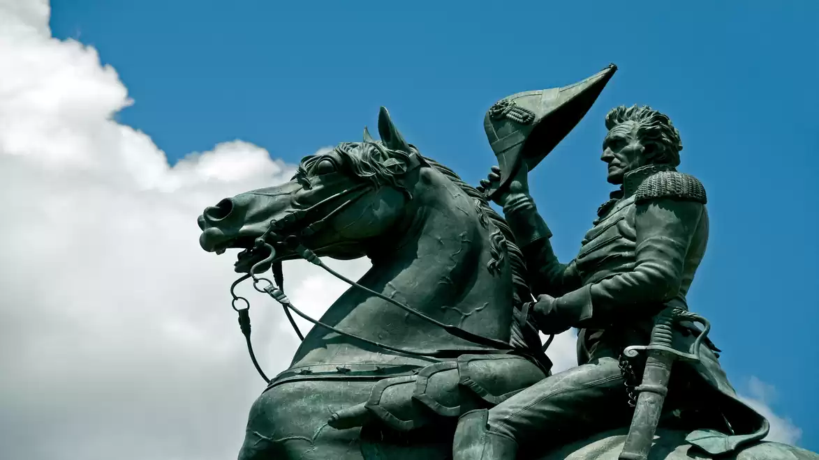 Equestrian statue against blue sky with clouds in the background