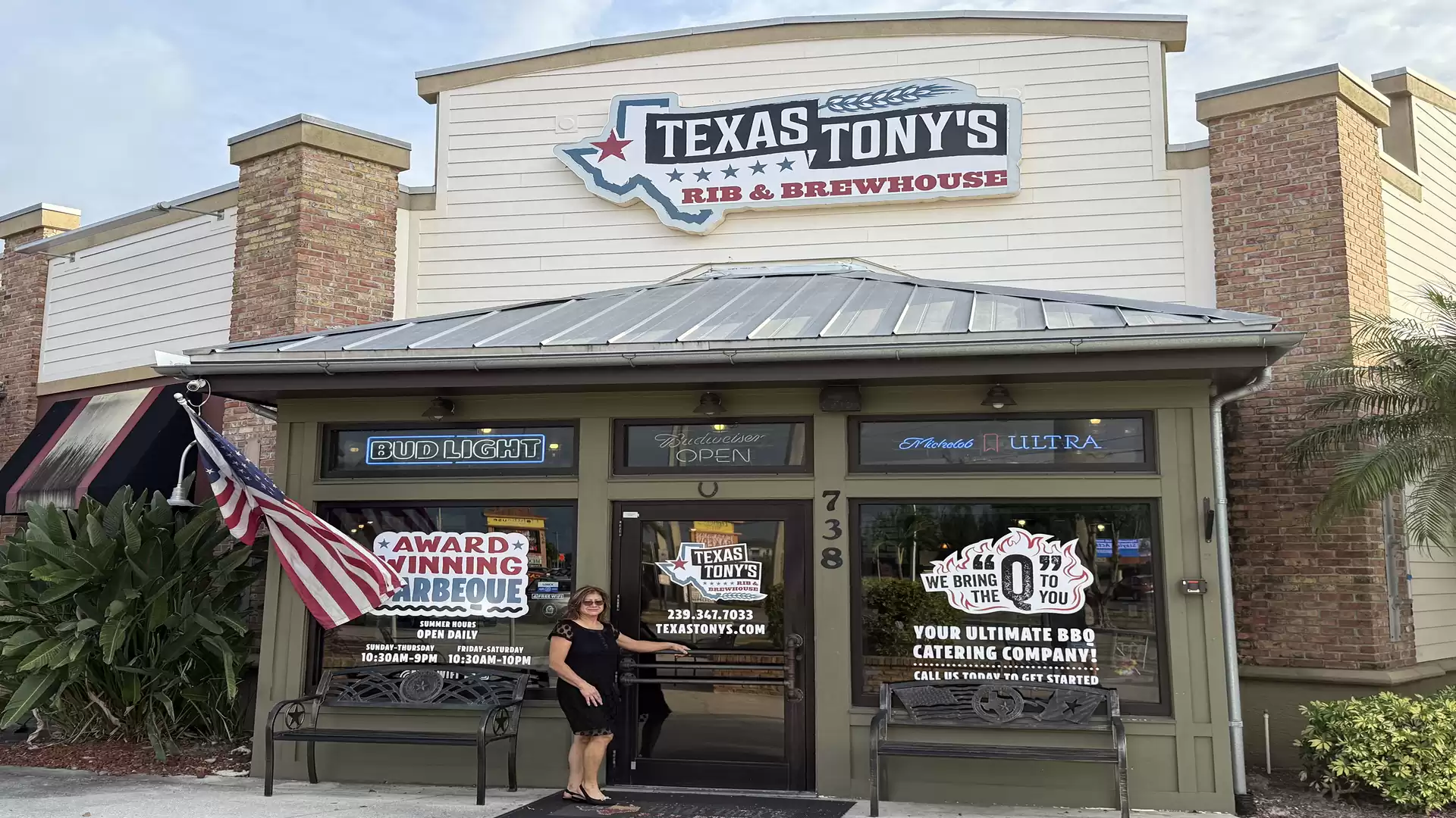 Exterior view of Texas Tony's Rib & Brewhouse with US flag and awards in the window.