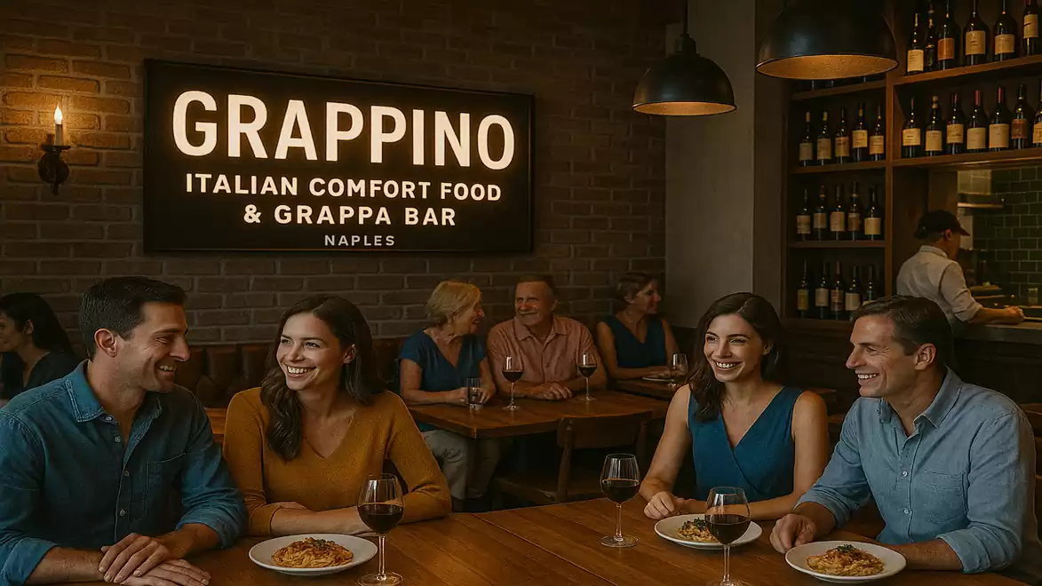 A group of people dining in an Italian restaurant called Grappino. They are sitting at a wooden table, enjoying pasta and conversing. In the background, more guests and wine bottles create a cozy atmosphere.