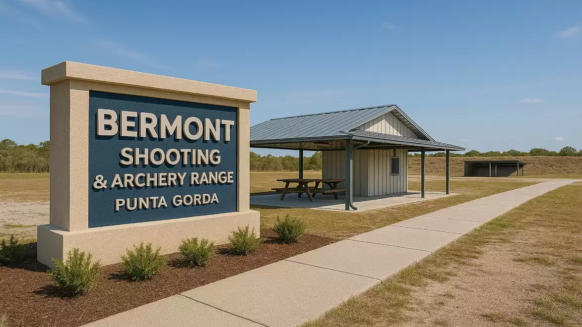 Exterior view of Bermont Shooting & Archery Range in Punta Gorda with a sign and a small covered building on a sunny day.