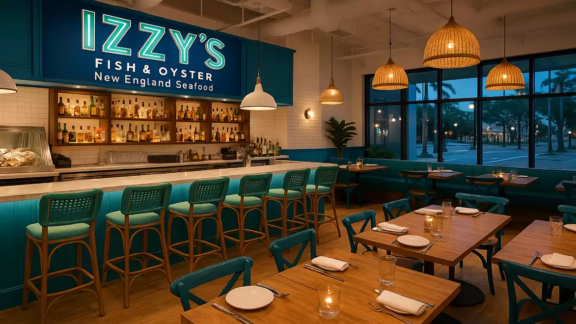 Interior of a stylish restaurant with wooden chairs and set tables, warm lighting, and a bar with blue accents.