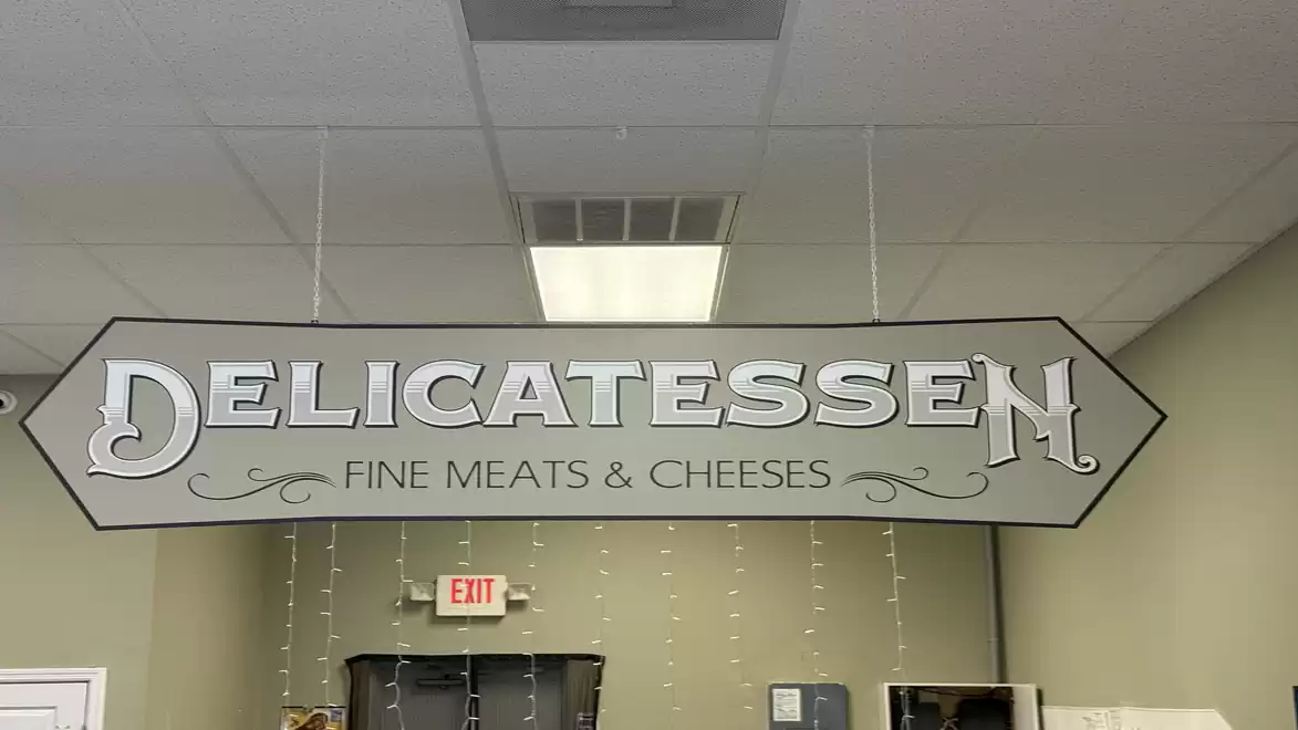 Deli sign in a store reading 'Fine Meats & Cheeses'.