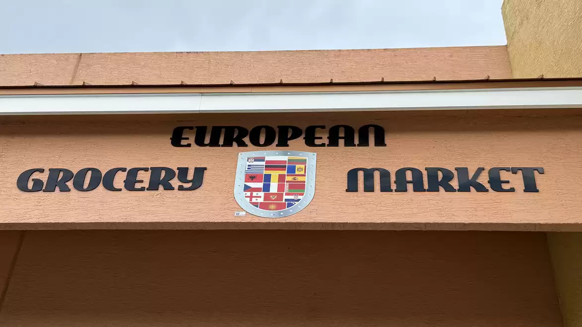 A sign reading 'European Grocery Market' with a colorful logo in the center.