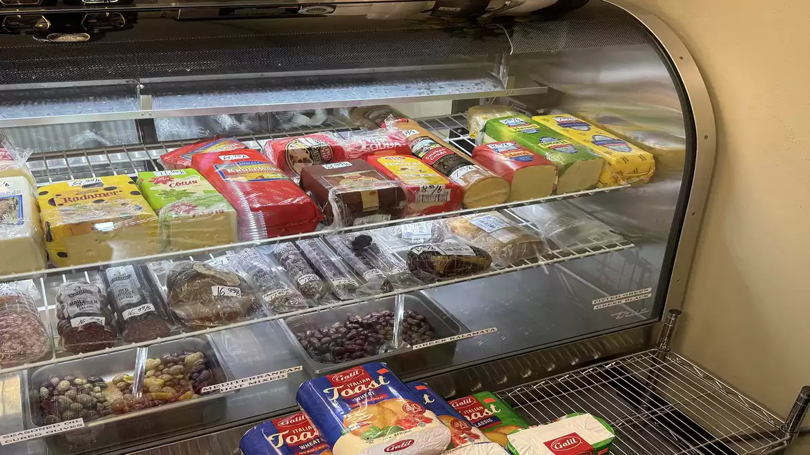 Food items in a refrigerator with various types of cheese and Turkish specialties.