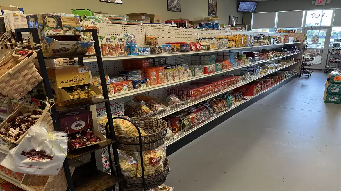 A well-stocked supermarket aisle with a variety of groceries and products on the shelves.