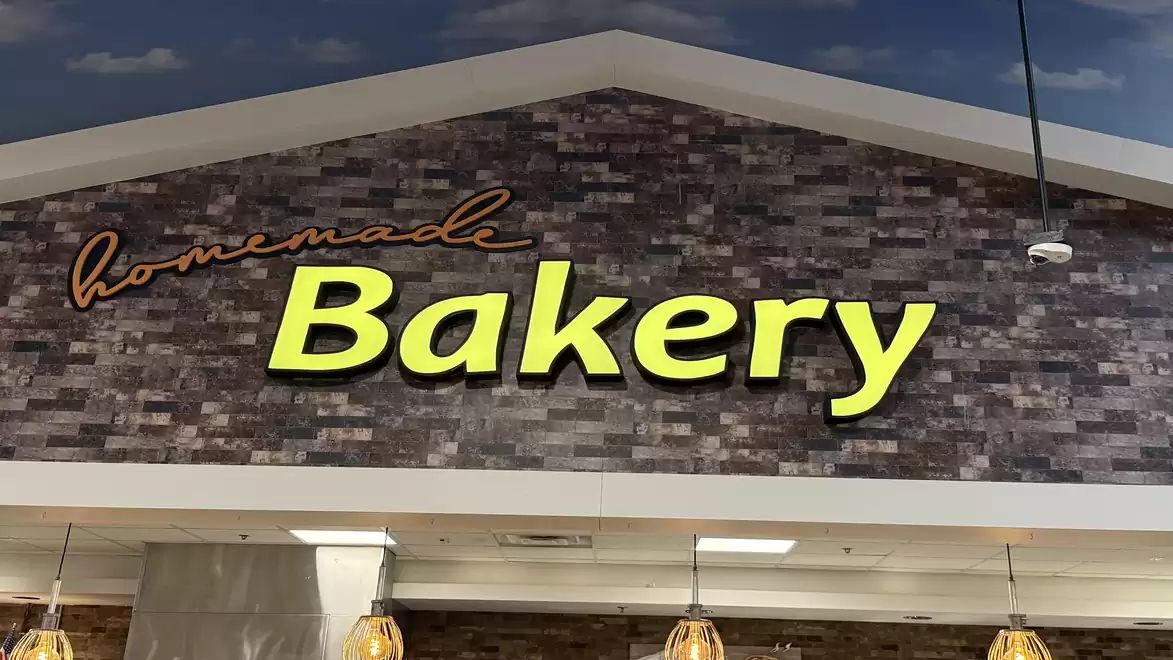 Facade of a bakery with the sign 'homemade Bakery' on a brick wall.