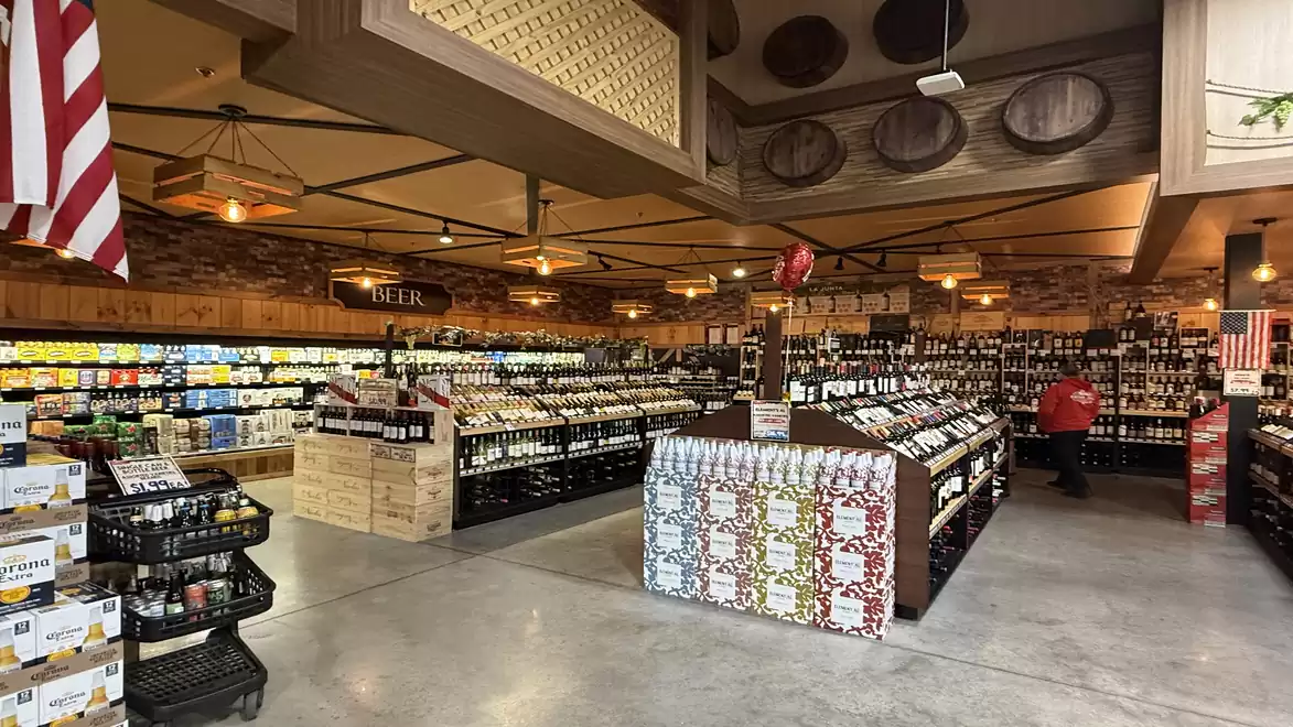 A well-stocked beer store with various types of beer in a shop with a warm, inviting atmosphere.