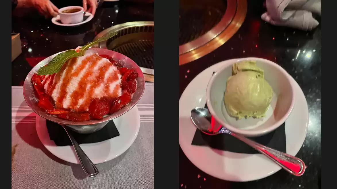 A dessert with strawberries and cream next to a bowl of green ice cream served on a table.