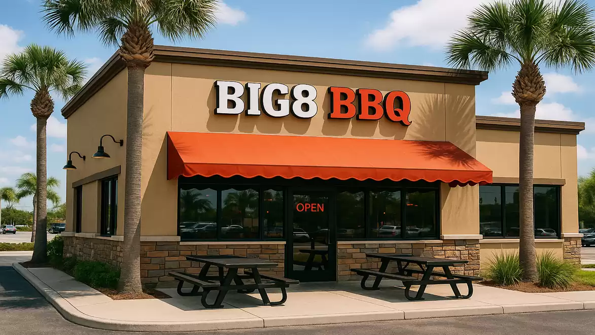 Exterior view of a BBQ restaurant with palm trees and an orange awning.