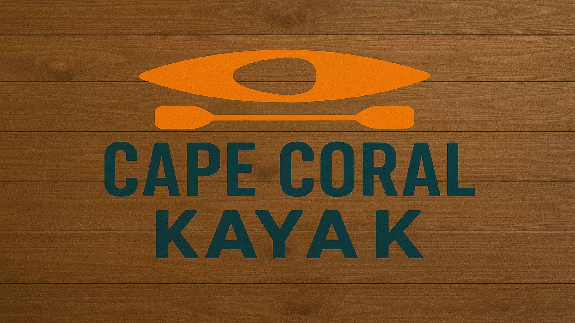 Cape Coral Kayak logo with orange kayak symbol on brown wood.