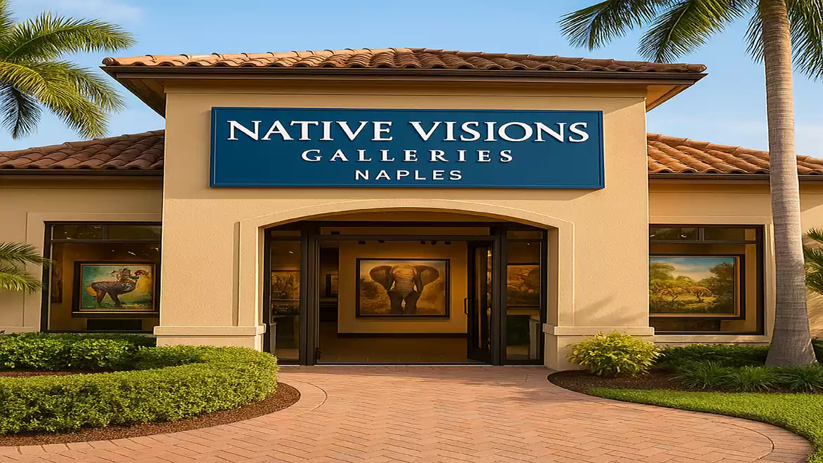 Entrance to Native Visions Gallery in Naples with artworks in windows. Palm trees and clear sky in the background.