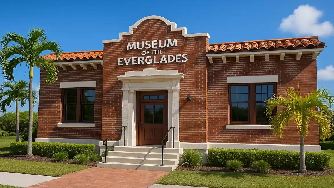 Brick building of the Museum of the Everglades with palm trees and blue sky in the background.