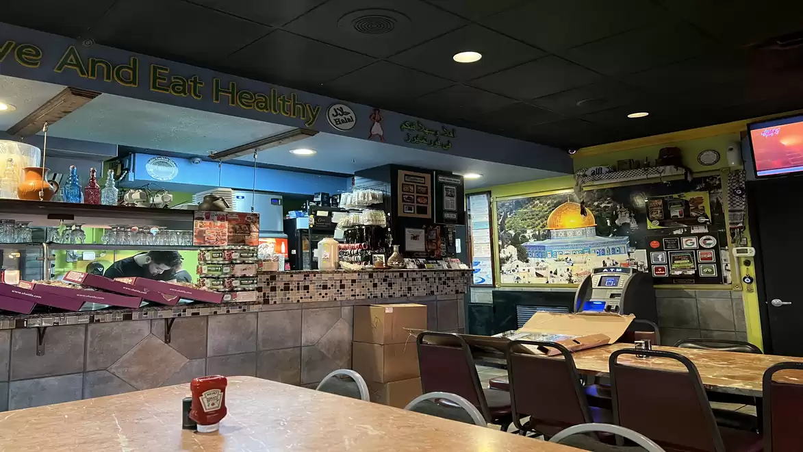 Image of a cozy café with table, chairs, and unique decorations.