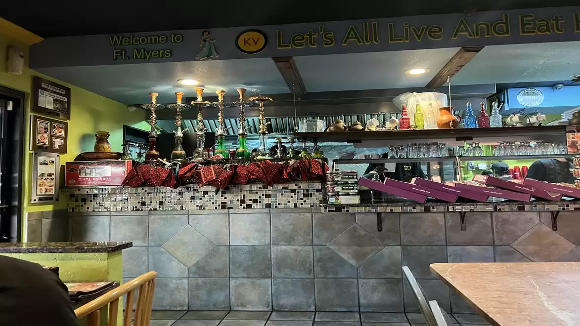Interior view of a tastefully decorated restaurant with a bar area and samovars.