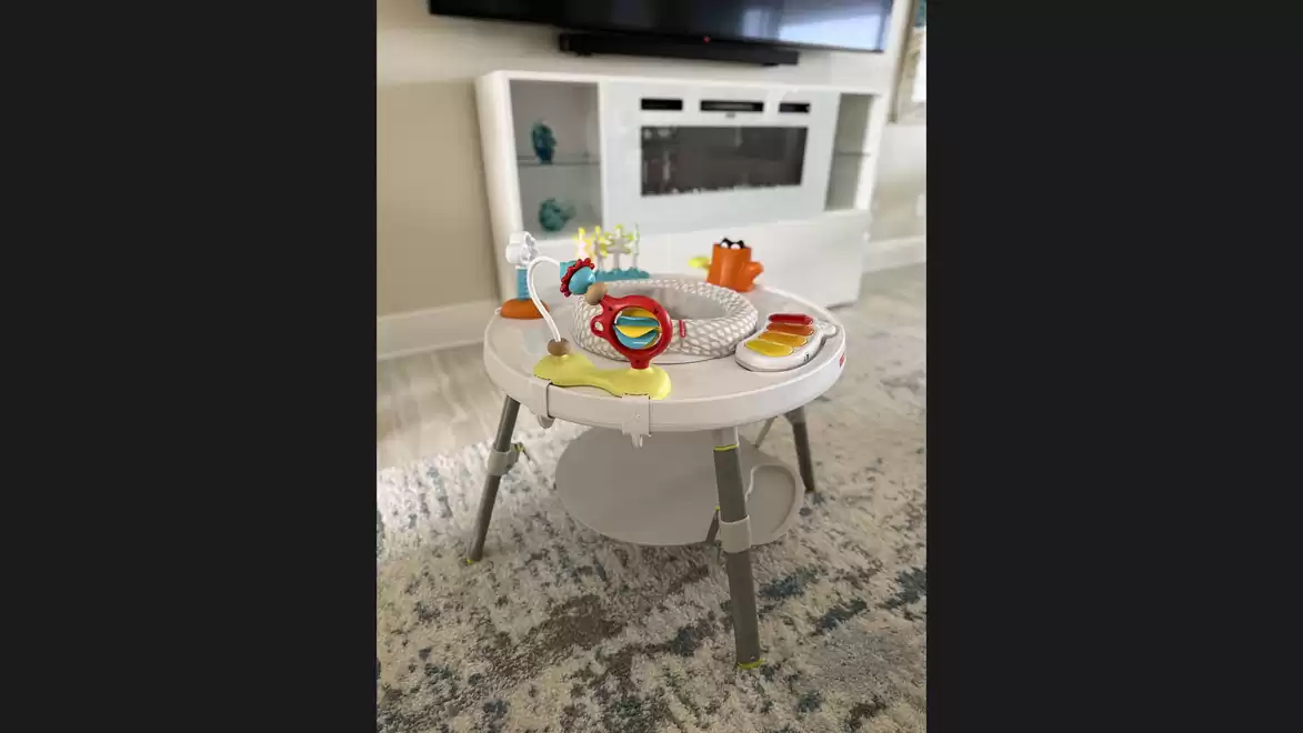 Children's play table with colorful toys in a modern living room.