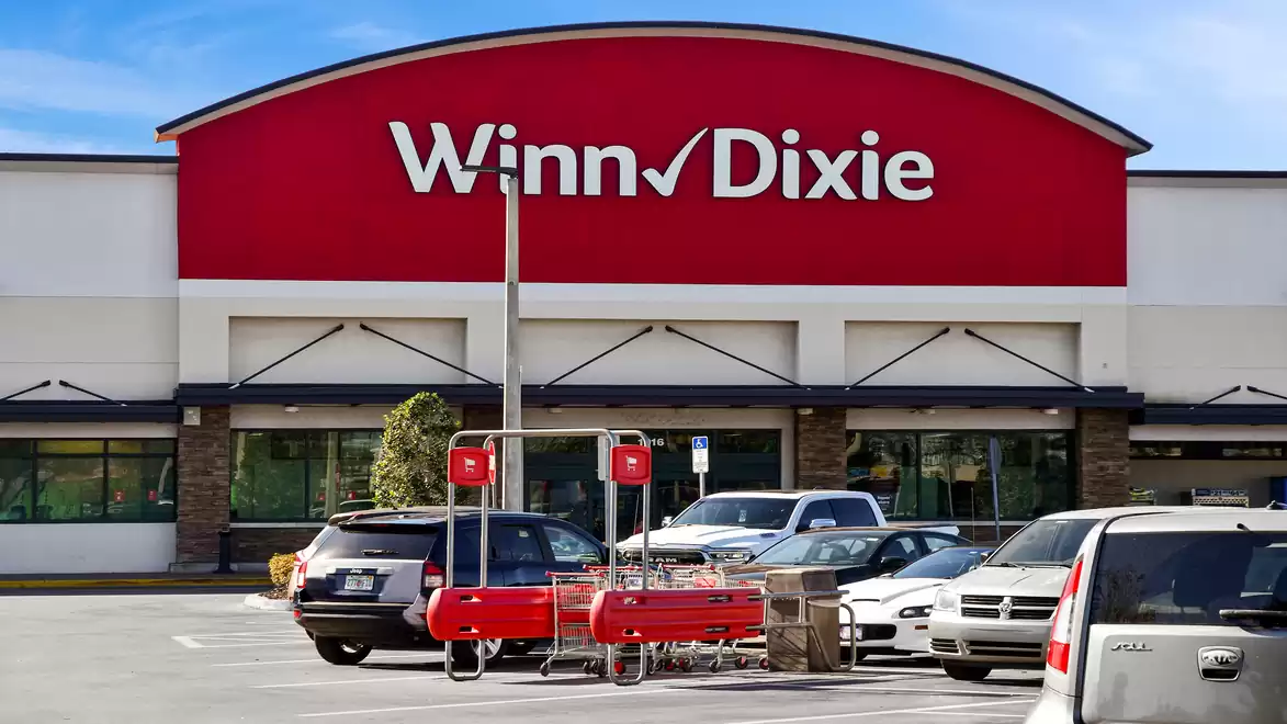 Winn-Dixie supermarket with parking lot and shopping carts in the foreground.