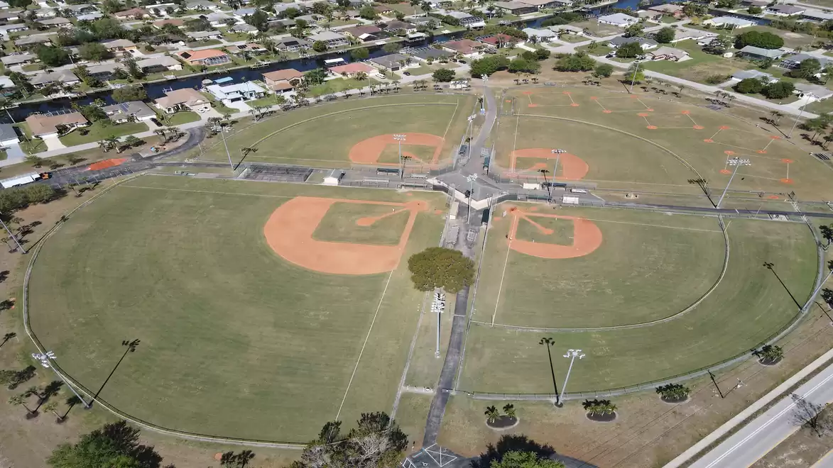Aerial view of a large sports complex with multiple baseball fields and surrounding residential area.