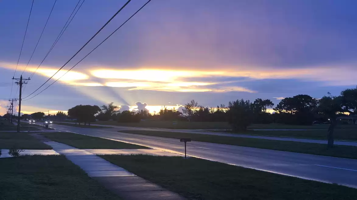 Road at sunset with dramatic sky and clouds.