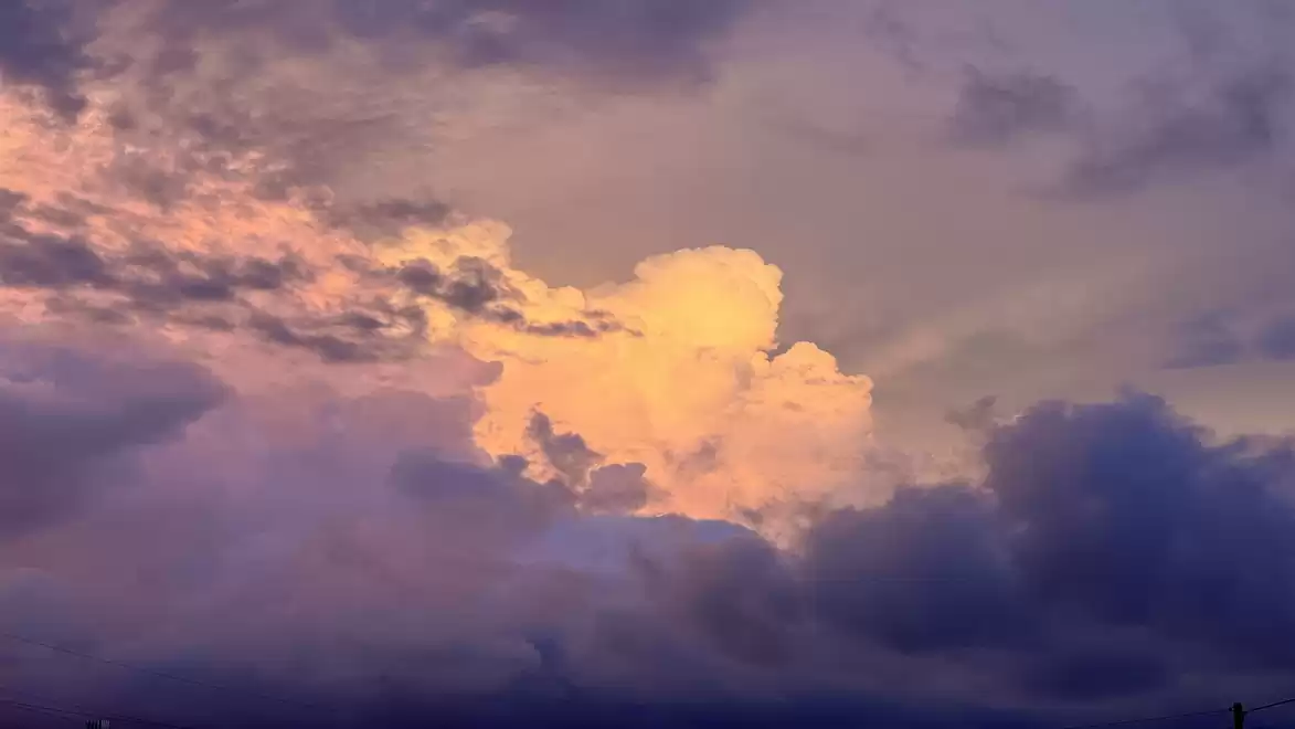 Beautiful sunset sky with purple and orange clouds, creating a dramatic effect.